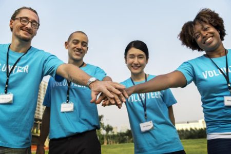 multiethnicity-volunteers-with-hands-their-stacked-together-in-a-huddle